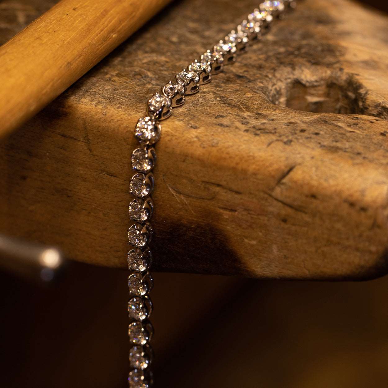 Diamond White Gold Tennis Bracelet on a wooden table