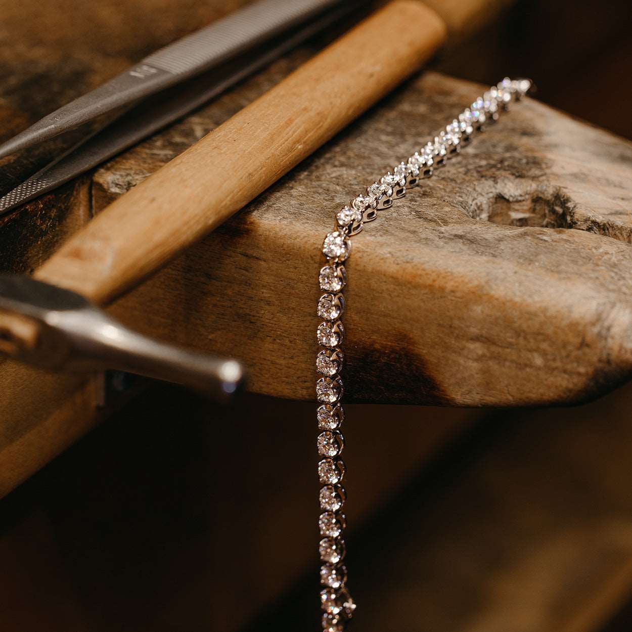 Diamond White Gold Tennis Bracelet on a wooden table