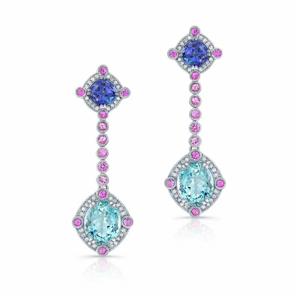 Luxurious sapphire and diamond dangle earrings on white.
