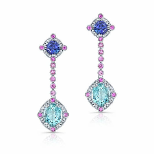 Luxurious sapphire and diamond dangle earrings on white.