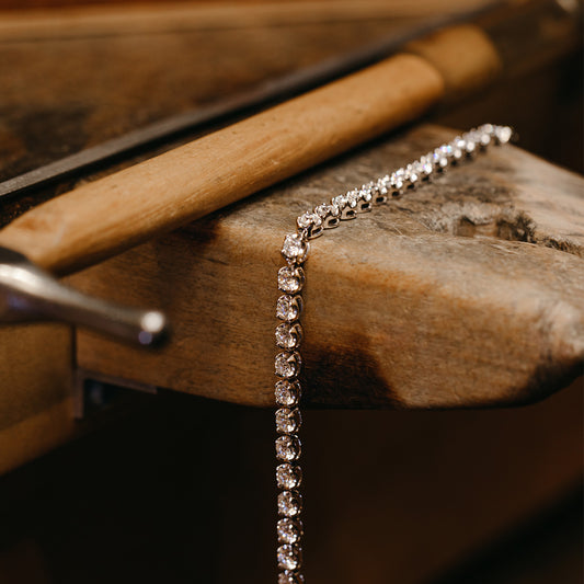 Diamond White Gold Tennis Bracelet on a wooden table