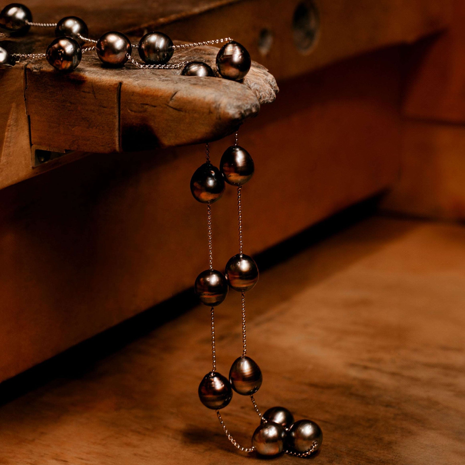 Black Tahitian Cultured Pearl Necklace on a wooden table