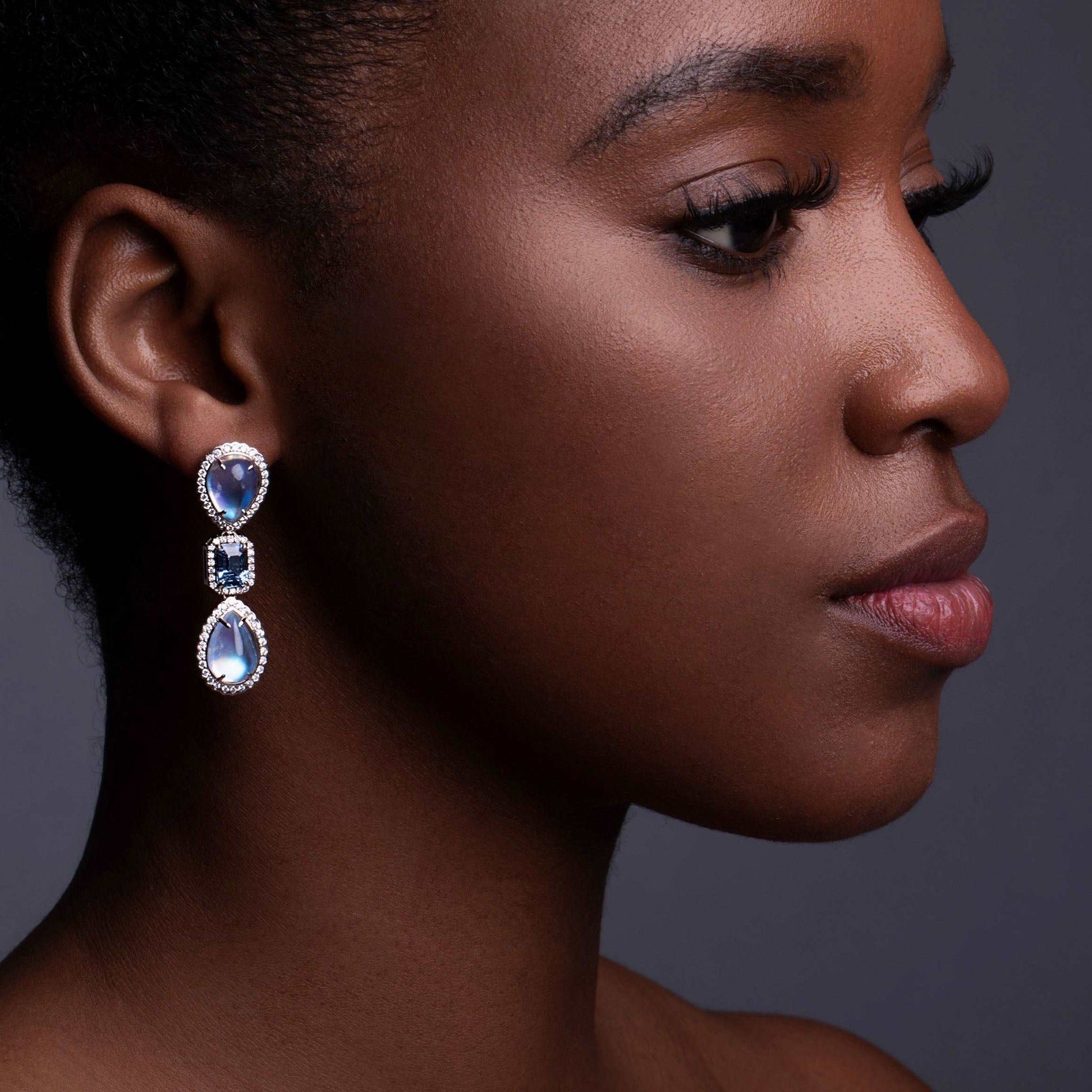 A model wearing Moonstone and Sapphire Drop Earrings