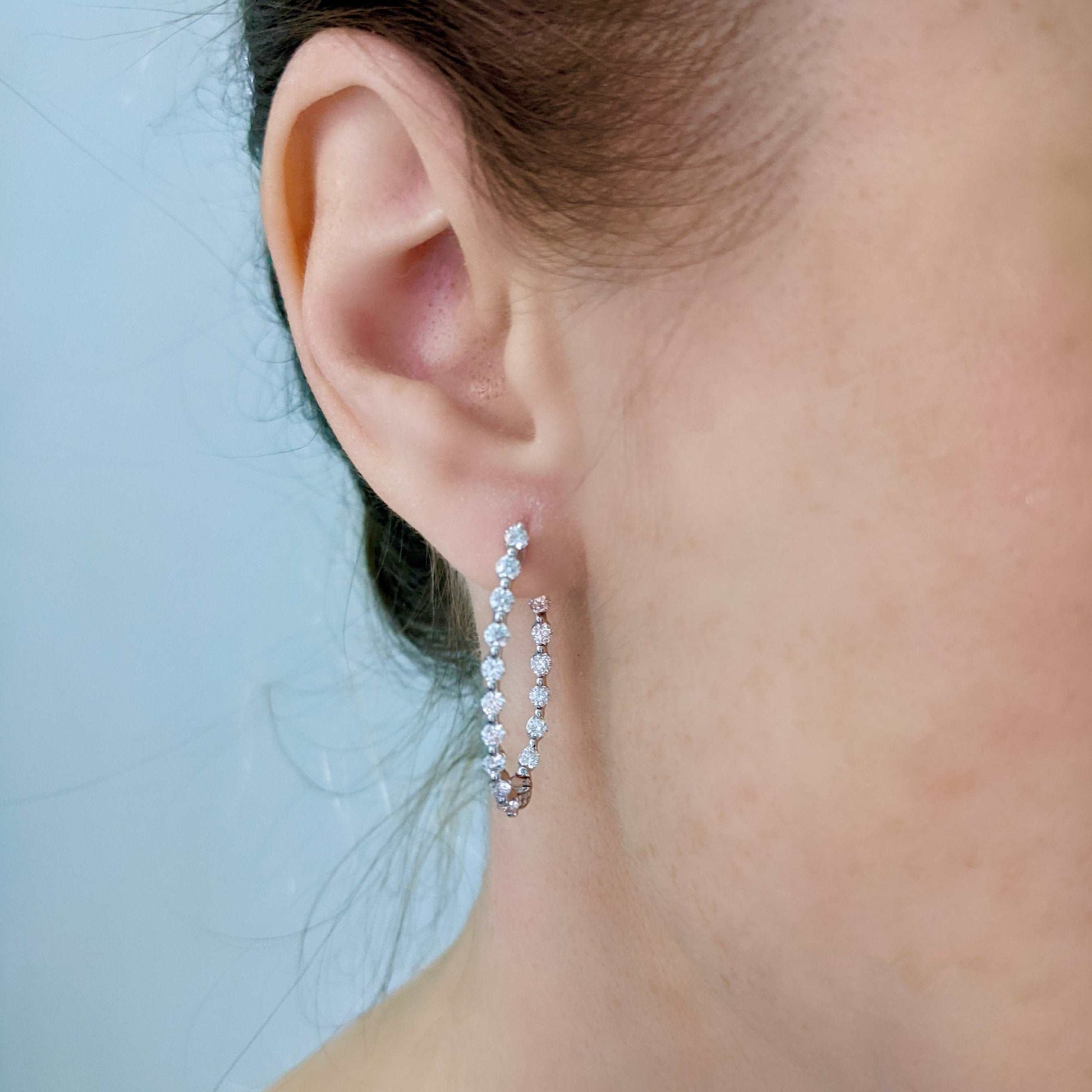 Model Wearing Diamond Hoop Earrings in 18k White Gold