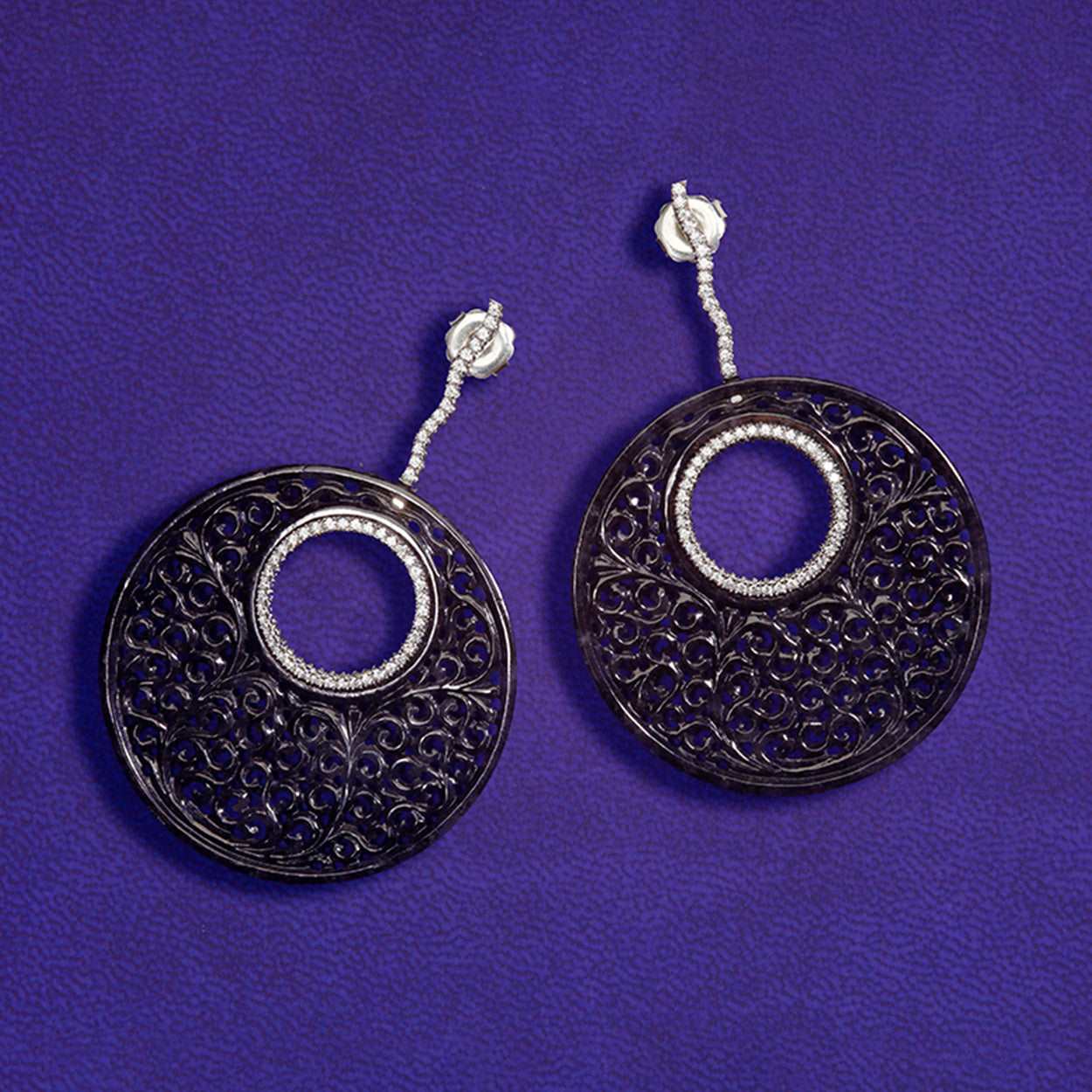 Black Jade Diamond Platinum Earrings on a purple background