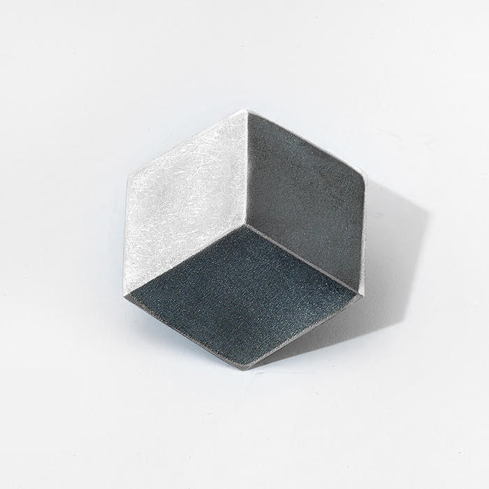 A hexagon shaped brooch, reminiscent of a 3D cube, in sterling silver.