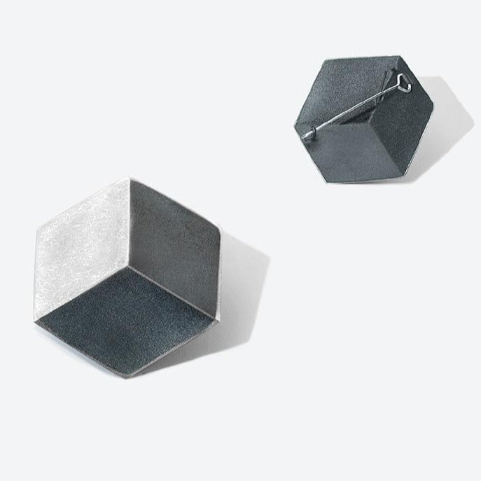 A hexagon shaped brooch, reminiscent of a 3D cube, in sterling silver.