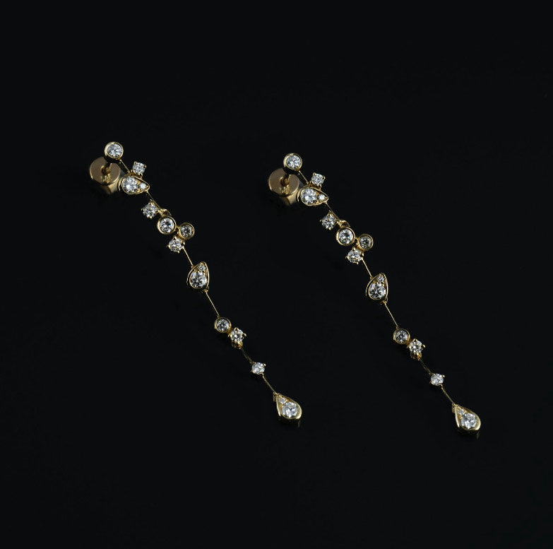 Diamond Gold Dangle Earrings on a black background