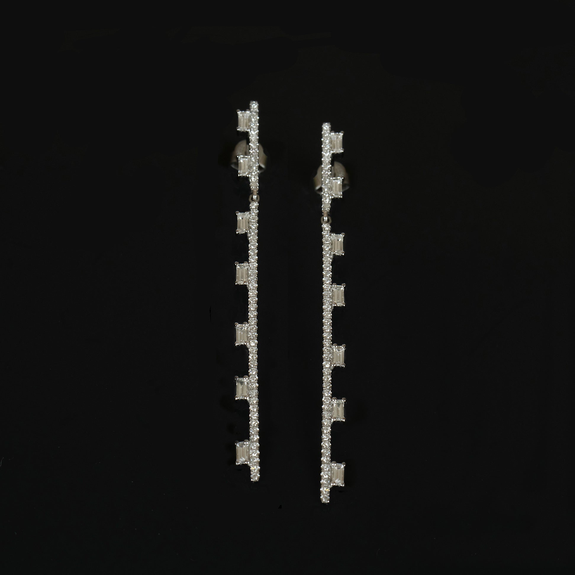 Baguette Diamond Drop Earrings on a black background